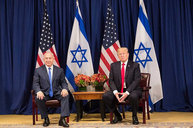 political leaders sitting and shaking hands